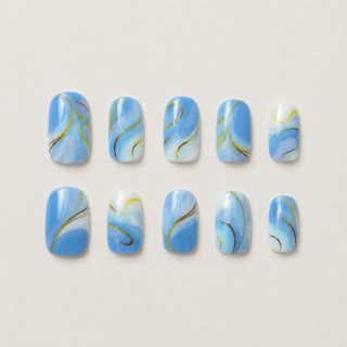 Golden Hour Waves blue and gold press-on nail set flat lay