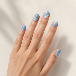 Golden Hour Waves blue and gold press-on nails worn on hand