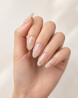 Golden Grace Fine-Line Floral Almond Press-On Nails worn on hand
