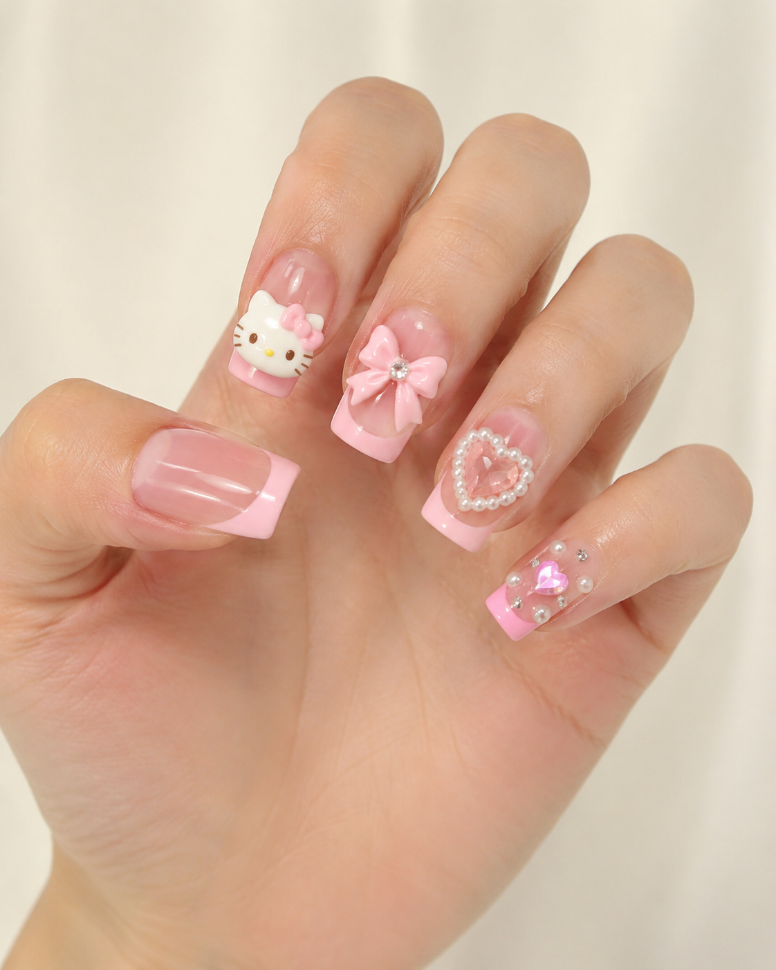 Kawaii Kitty Coquette Pink French Tip Press-On Nails worn on hand
