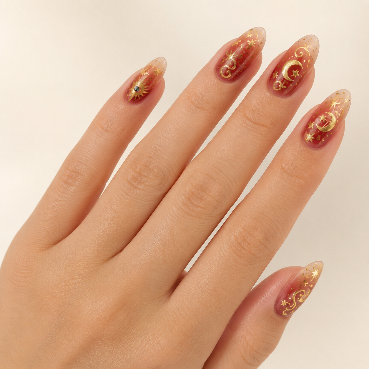 Cosmic Crimson & Metallic Gold Evil Eye Almond Press-On Nails worn on hand