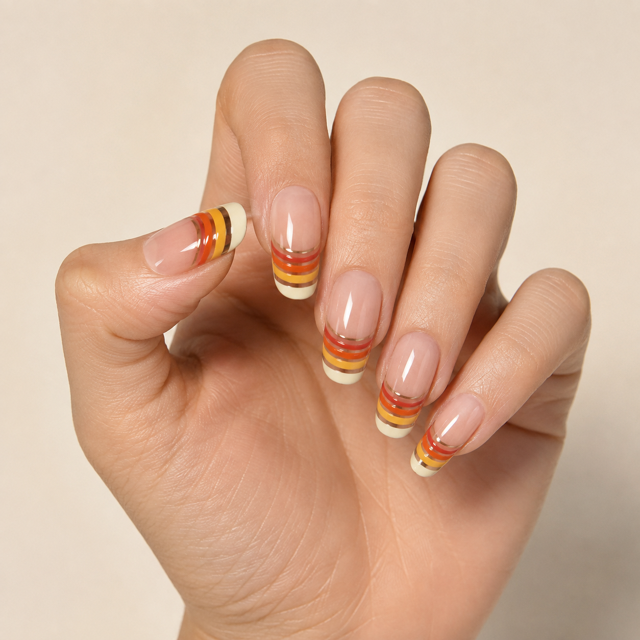 70s Retro Sunset Striped French Oval Almond Press-On Nails worn on hand