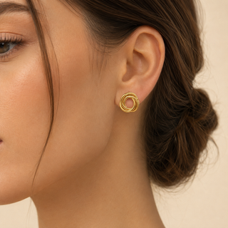 Model wearing Sculpted Triple-Ring Gold Stud Earrings