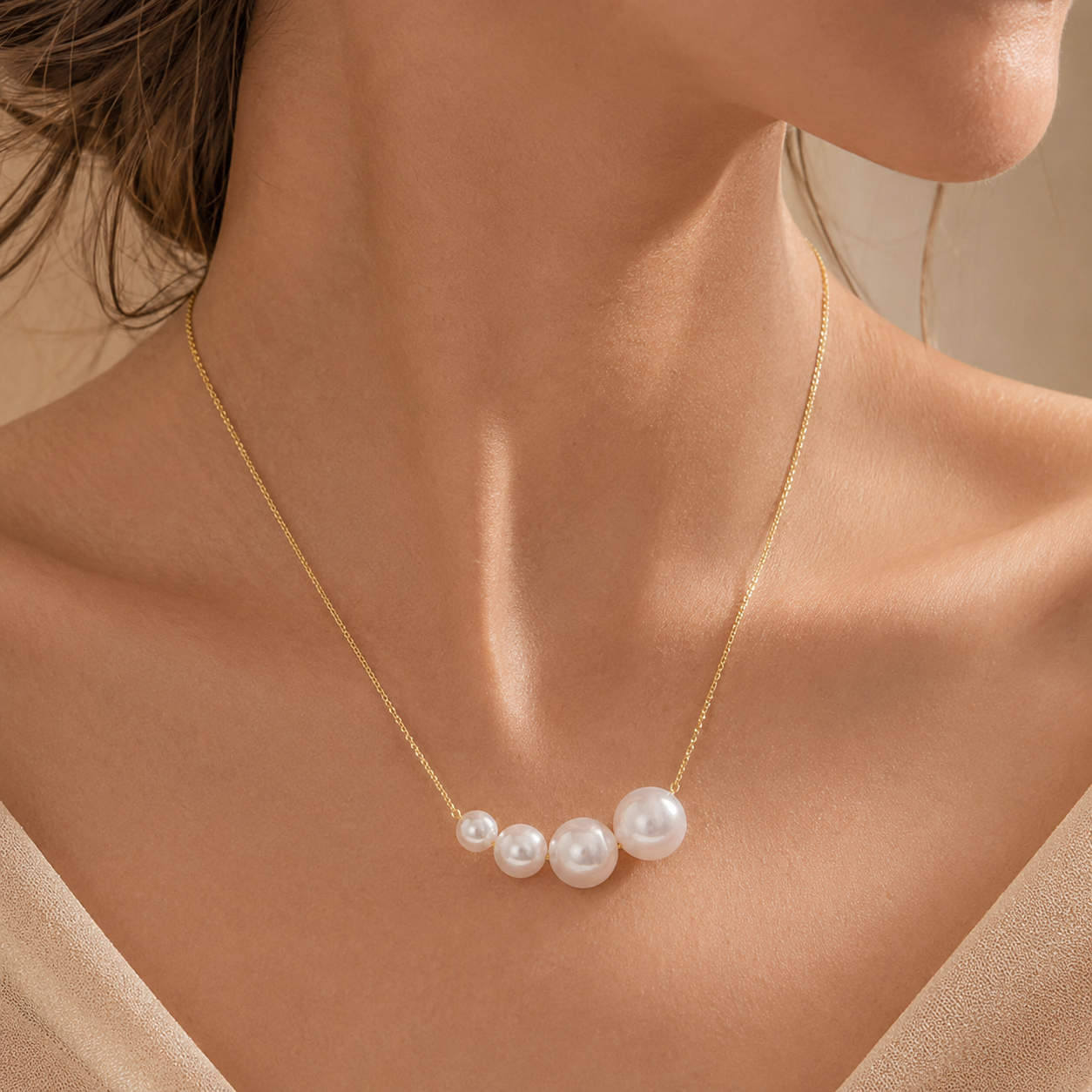 Model wearing Graduated Pearl Gold Necklace